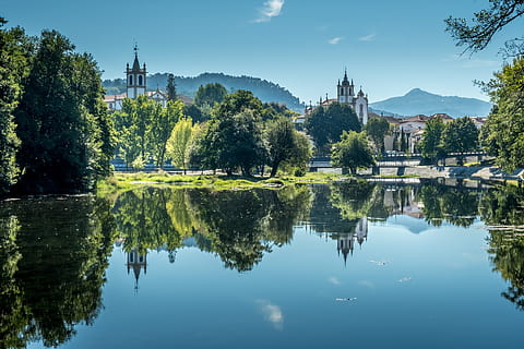 water between trees, water, nature, outdoors, steeple, architecture, building, spire, tower, tree, plant, castle, fir, abies, pond, grass, landscape, scenery, land, lake, fort, reflection, built structure, building exterior, sky, waterfront, religion, place of worship, spirituality, belief, travel destinations, day, no people, 5K, CC0, public domain, royalty free