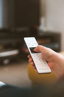 white remote, controller, hand, human hand, human body part, technology, wireless technology, one person, holding, connection, communication, real people, telephone, mobile phone, smart phone, indoors, portable information device, lifestyles, women, using phone, adult, finger, 5K, CC0, public domain, royalty free