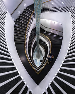 spiral stairs, architecture, man, person, perspective, staircase, stairs, pattern, steps and staircases, built structure, indoors, metal, spiral, railing, no people, high angle view, design, modern, spiral staircase, shape, geometric shape, illuminated, directly above, circle, ceiling, 2K, CC0, public domain, royalty free