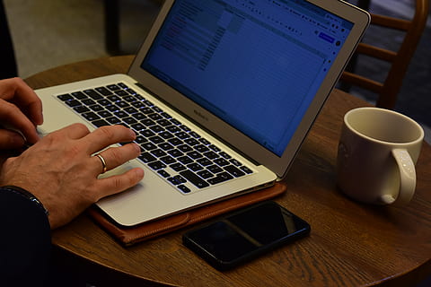 work, computer, laptop, writing, analysis, coffee, mug, phone, iphone, wedding ring, guy, table, hands, cafe, technology, wireless technology, communication, connection, real people, using laptop, portable information device, indoors, cup, human hand, one person, high angle view, drink, human body part, hand, keyboard, surfing the net, finger, 5K, CC0, public domain, royalty free