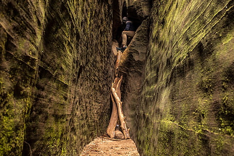 man, inside, cave, narrow, pathway, nature, green, climb, wall, algae, moss, stone, rock, driftwood, slot canyon, crevasse, canyon, dirt road, gravel, road, hike, explore, adventure, travel, day, tree, leisure activity, solid, rock - object, land, outdoors, lifestyles, rock formation, real people, full length, plant, one person, low angle view, climbing, geology, men, tree trunk, 5K, CC0, public domain, royalty free