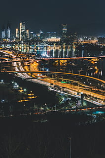 road, intersection, way, town, city, building, metropolis, urban, landscape, nature, outdoors, highway, scenery, aerial view, overpass, downtown, architecture, plan, plot, diagram, building exterior, night, illuminated, built structure, cityscape, no people, water, sky, high angle view, transportation, long exposure, connection, glowing, river, light trail, bridge - man made structure, modern, office building exterior, skyscraper, 5K, CC0, public domain, royalty free