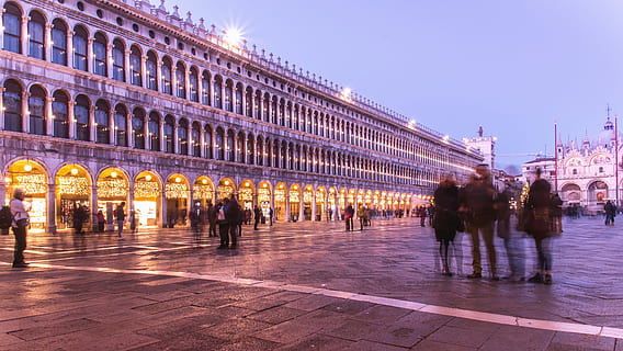 piazza san marco, venice, night, architecture, city, building exterior, built structure, group of people, travel destinations, illuminated, crowd, travel, tourism, motion, large group of people, city life, walking, real people, street, history, blurred motion, outdoors, architectural column, 4K