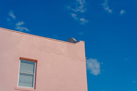edifici pintat de color rosa, núvol - cel, cel, arquitectura, exterior de l'edifici, estructura construïda, finestra, blau, edifici, naturalesa, vista d’angle baix, cap gent, dia, llum solar, a l'aire lliure, casa, funció de construcció de parets, barri residencial, color taronja, ciutat, secció alta, en blanc, 5K, CC0, domini públic, lliure de regalies