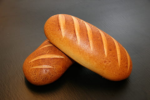 two, brown, baked, breads, table, bread, buns, close-up, delicious, dining, food, healthy, loaf, nutrition, still life, tasty, toast, food and drink, healthy eating, freshness, wellbeing, indoors, orange color, fruit, no people, studio shot, wood - material, loaf of bread, simplicity, seed, slice, orange, french food, brown bread, 2K, CC0, public domain, royalty free