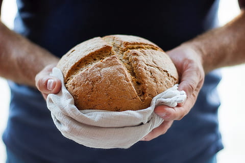 freshly baked bread, bake, baked, bakery, bread, fresh, hands, person, human hand, hand, human body part, food, food and drink, one person, holding, baking bread, freshness, adult, close-up, midsection, indoors, occupation, men, loaf of bread, breakfast, chef, 5K