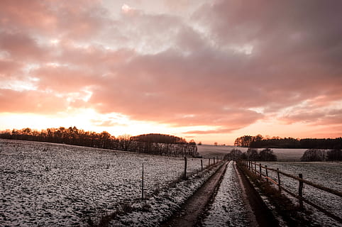 empty gray road, nature, outdoors, sunset, snow, sunrise, landscape, winter, road, light, flare, ground, trail, gravel, dirt road, sky, sunlight, sun, snowfall, cold, moody, cloud - sky, transportation, scenics - nature, tranquility, beauty in nature, no people, tranquil scene, environment, the way forward, land, direction, rural scene, dramatic sky, diminishing perspective, 4K, CC0, public domain, royalty free
