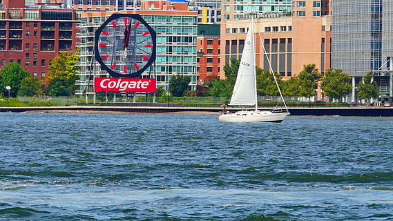 small, sailboat sails, hudson river, pass, colgate clock, jersey city, city., pictures of sailboats, sailboat pictures, boat pictures, sailing boat, boat images, pictures of boats, new york harbor, buildings, sail, water, new york city harbor, waves, new jersey, water front, nautical vessel, transportation, mode of transportation, architecture, sea, building exterior, built structure, no people, nature, waterfront, travel, day, building, text, sailboat, city, sailing, outdoors, passenger craft, luxury, yacht, 2K