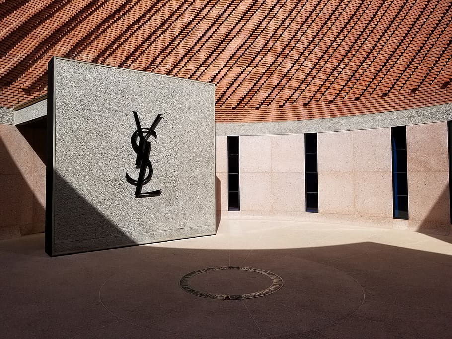 logotip de ysl, estructura construïda, arquitectura, representació, art i artesania, cap gent, representació humana, exterior de l'edifici, dia, ombra, llum solar, edifici, funció de construcció de parets, naturalesa, a l'aire lliure, creativitat, forma, semblança masculina, creença, patró, assolellat, 4K