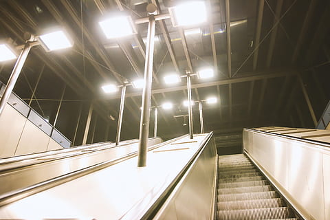 gray escalator, architecture, ceiling, empty, escalator, lights, perspective, illuminated, lighting equipment, indoors, railing, staircase, steps and staircases, built structure, no people, modern, low angle view, transportation, direction, absence, technology, convenience, the way forward, light, diminishing perspective, electricity, 4K, CC0, public domain, royalty free