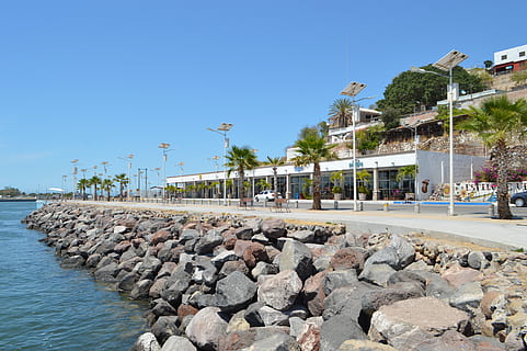port, beach, spring, landscape, lake, jetty, water, sky, nature, architecture, built structure, clear sky, tree, incidental people, plant, building exterior, tropical climate, rock, palm tree, day, blue, solid, rock - object, sunlight, travel destinations, outdoors, swimming pool, 4K, CC0, public domain, royalty free