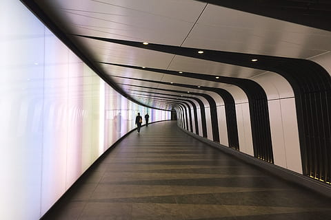 futuristic tunnel, architecture, the way forward, direction, illuminated, indoors, transportation, walking, built structure, ceiling, arcade, corridor, diminishing perspective, flooring, lighting equipment, incidental people, real people, public transportation, subway, motion, footpath, tiled floor, 2K