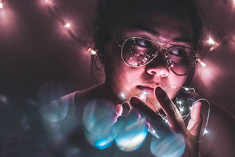 woman, holding, string lights, fun, lights, person, glasses, eyeglasses, adult, young adult, portrait, people, illuminated, women, technology, night, indoors, headshot, lighting equipment, men, serious, females, human body part, gesturing, dark, teenager, nightlife, 2K, CC0, public domain, royalty free