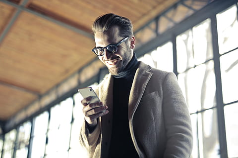 man, smiling, mobile, device, phone, glasses, fashion, suit, jacket, happy, people, technology, building, wireless technology, mobile phone, smart phone, portable information device, communication, one person, connection, lifestyles, young adult, telephone, holding, young men, men, leisure activity, front view, portrait, indoors, 5K, CC0, public domain, royalty free