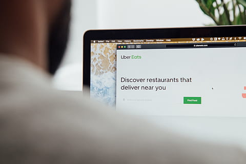 electronics, computer, uber, uber eats, take out, delivery, display, monitor, screen, laptop, pc, lcd screen, text, phone, tablet computer, cell phone, mobile phone, furniture, table, desktop, communication, technology, wireless technology, connection, one person, selective focus, adult, holding, indoors, close-up, over the shoulder view, rear view, digital tablet, convenience, internet, computer network, 5K, CC0, public domain, royalty free