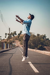 man jumping, fun, jump, jumping, man, person, road, full length, one person, real people, casual clothing, leisure activity, lifestyles, sunlight, transportation, human arm, sky, direction, nature, young adult, young men, the way forward, men, city, standing, outdoors, arms raised, 5K, CC0, public domain, royalty free