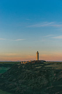 lighthouse during daytime, sky, built structure, architecture, tower, sunset, building exterior, scenics - nature, lighthouse, tranquility, beauty in nature, safety, cloud - sky, tranquil scene, guidance, nature, protection, direction, no people, security, building, outdoors, 4K, CC0, public domain, royalty free