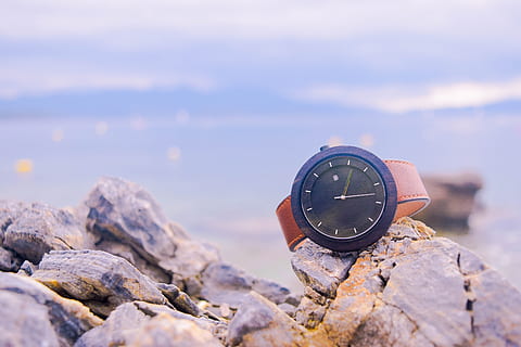 brown, black, round analog, watch, beige, rocks, beach, blue, blur, close-up, dawn, happiness, landscape, scene, seashore, stone, summer, sunset, time, solid, rock, rock - object, nature, sky, cloud - sky, beauty in nature, focus on foreground, no people, water, outdoors, sea, day, scenics - nature, instrument of time, clock, land, 5K, CC0, public domain, royalty free