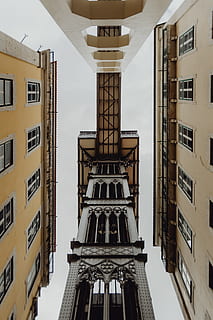 view, historic, elevator, lisbon, portugal, lift, santa justa lift, built structure, building exterior, architecture, building, residential district, city, window, no people, day, low angle view, sky, outdoors, apartment, balcony, tall - high, nature, city life, travel destinations, house, tower, directly below, 2K, CC0, public domain, royalty free