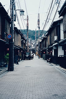 black, car, paced, road, kyoto, built structure, architecture, building exterior, city, the way forward, direction, transportation, street, cable, building, mode of transportation, sky, electricity, day, nature, no people, diminishing perspective, cobblestone, residential district, outdoors, power supply, paving stone, 5K, CC0, public domain, royalty free
