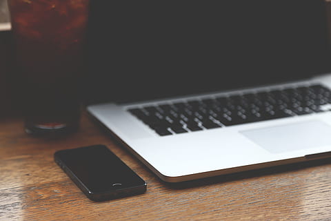 black, iphone 7, silver macbook, pro, blur, blurred, computer, iphone, macbook, smartphone, technology, wireless technology, communication, connection, laptop, table, portable information device, smart phone, mobile phone, wood - material, portability, indoors, no people, internet, close-up, copy space, business, still life, computer equipment, dark, keyboard, 5K, CC0, public domain, royalty free