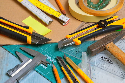 yellow utility knives, blade, cut, cutter, sharp, steel, tools, pencil, ruler, still life, work tool, high angle view, art and craft, tool, indoors, table, hand tool, wood - material, no people, workshop, instrument of measurement, hammer, scissors, directly above, large group of objects, multi colored, equipment, art and craft equipment, hand saw, 5K, CC0, public domain, royalty free